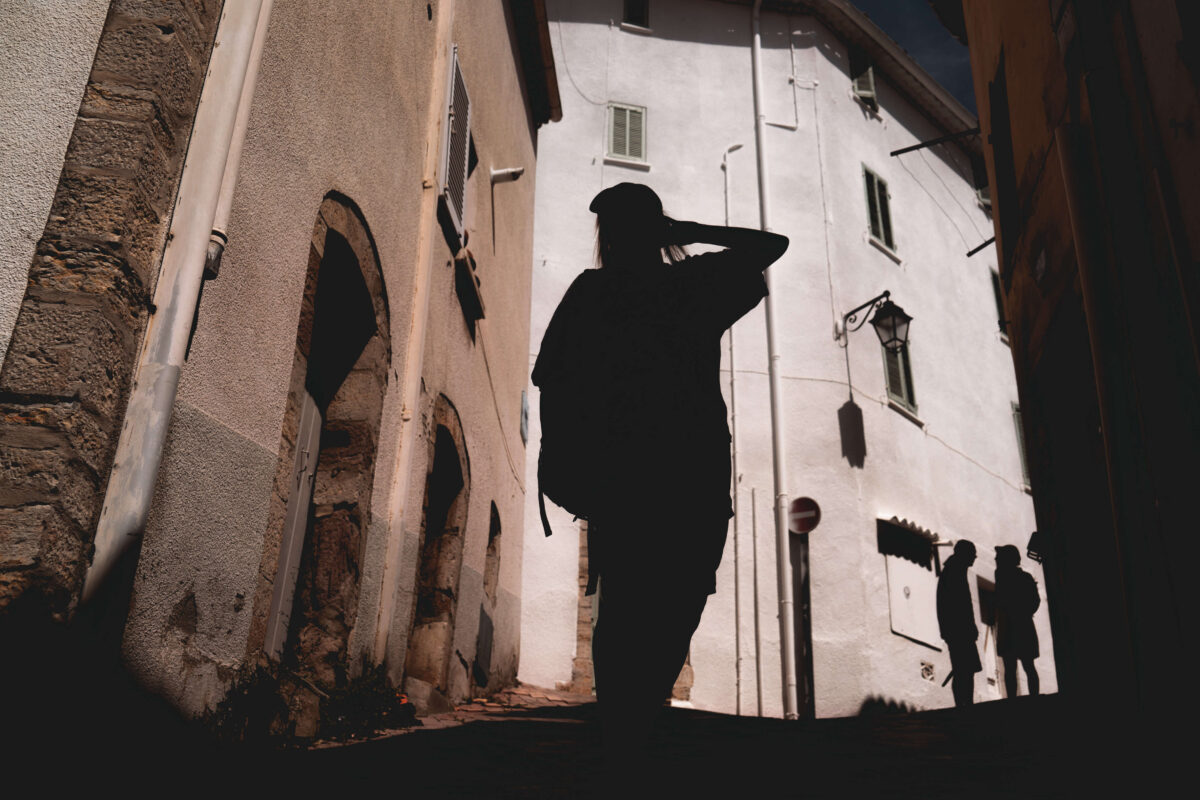 Silhouettes of people on a street in a southern city