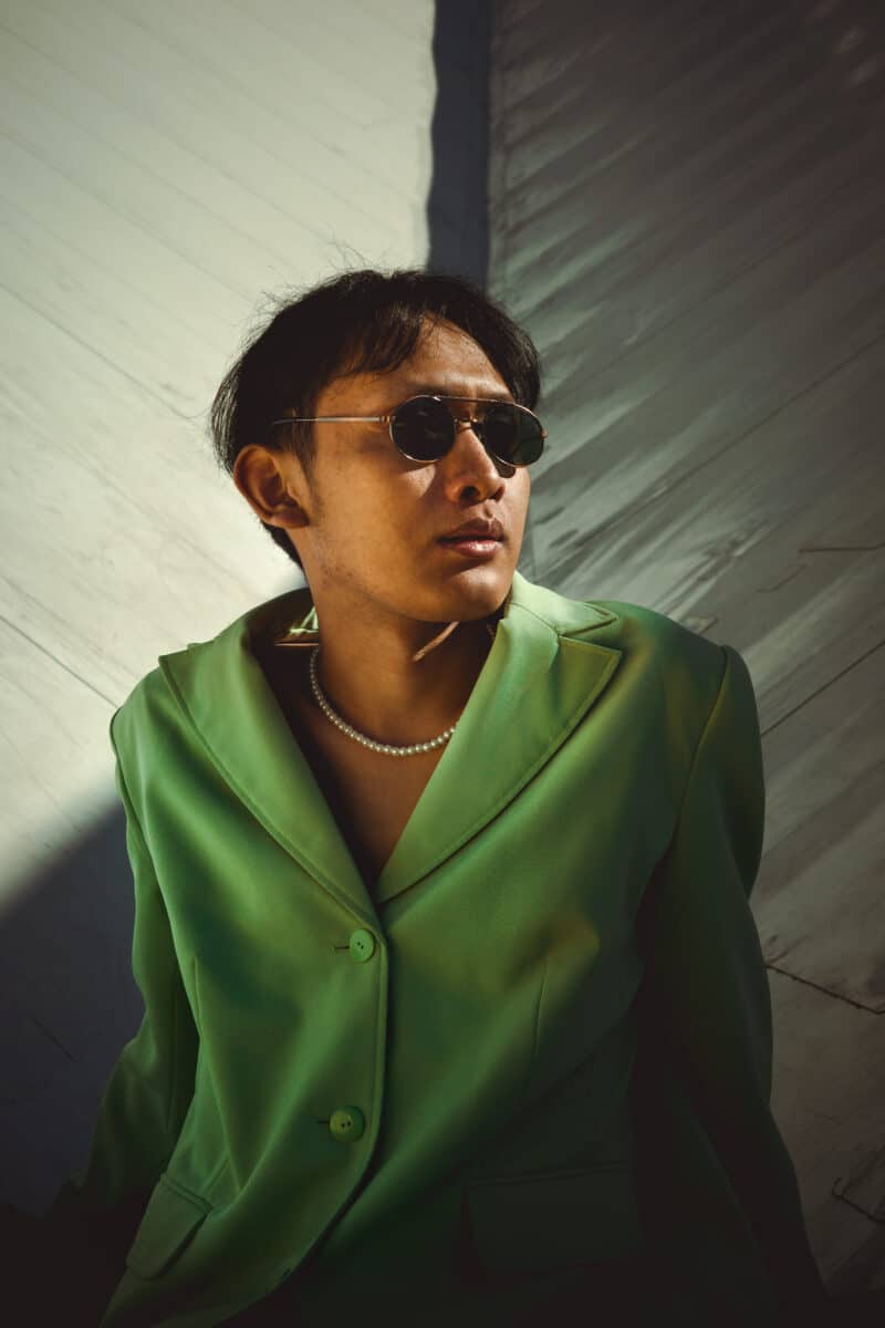 Edited photo of a young man in green blazer
