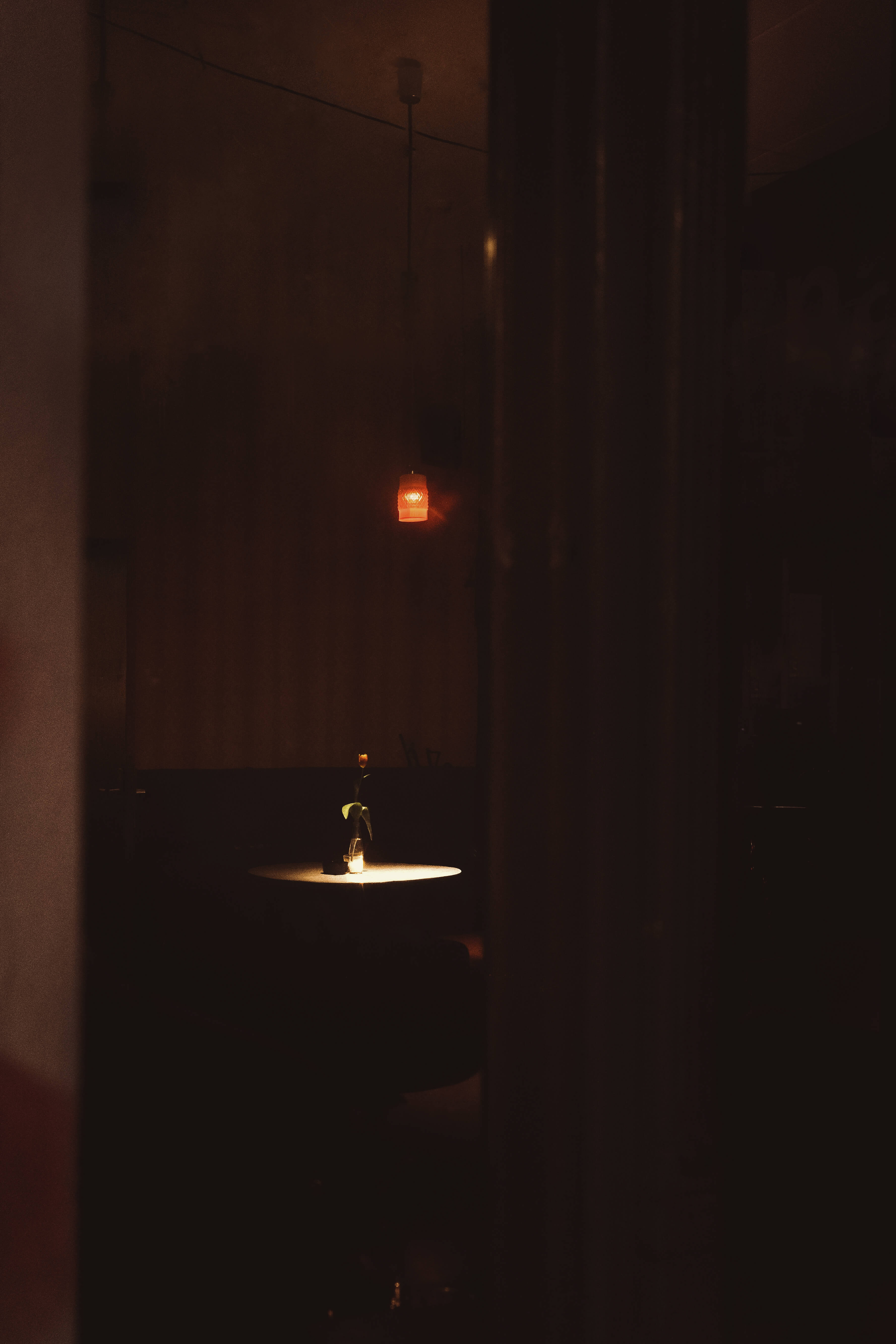 Low key image of a table in a bar for Ricoh GRIIIx review