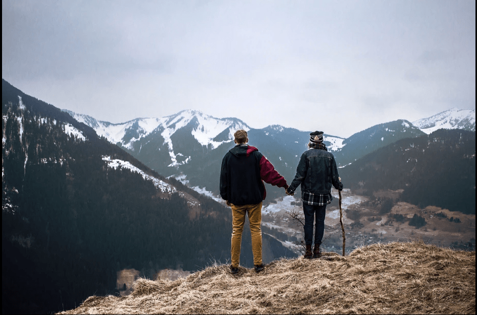 Photographer Fedor Vasilev and Anna Ivahnenko are standing on a mountain 