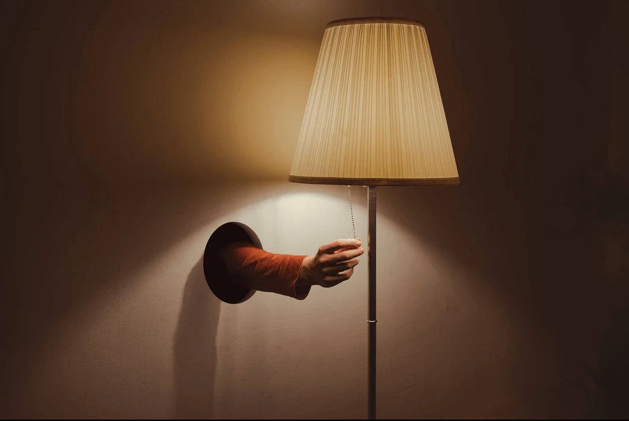 Surrealist photograph of a hand turning off the lamp made on my best prime lens
