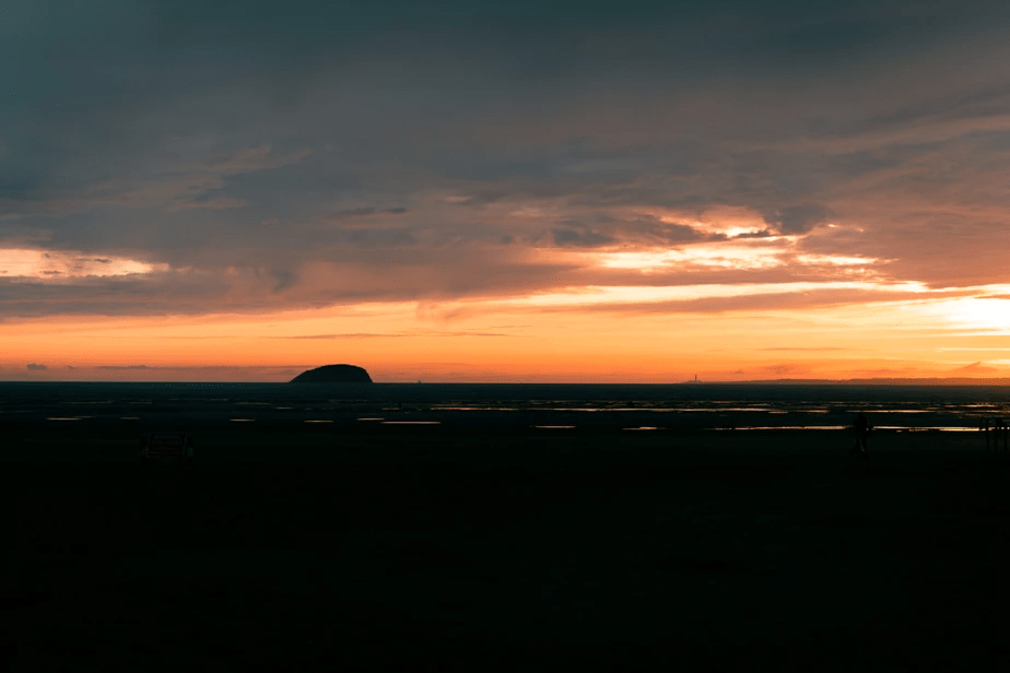 Landscape photograph of a sea during low tide taken at sunset on a fixed lens