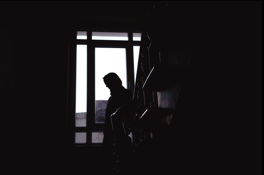 Silhouette of a woman in a staircase. Example of a shot made on Ricoh GRIIIx