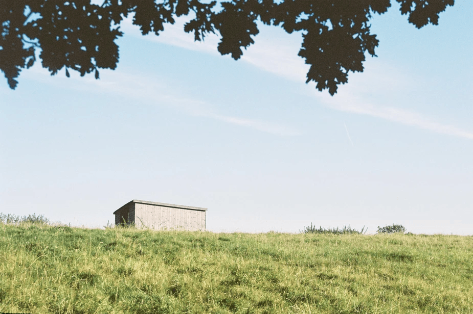 film photograph of a little house on a hill