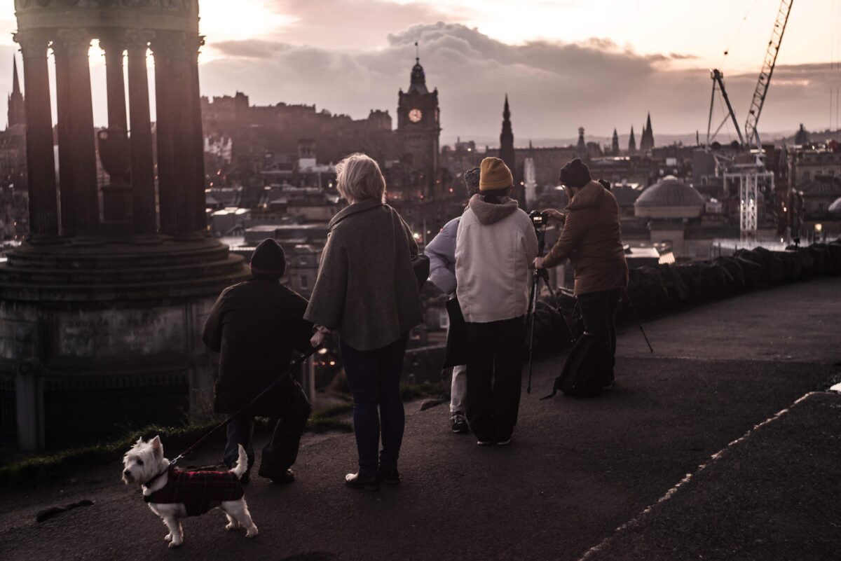 A crowd of people photographing the view on Edinburgh
