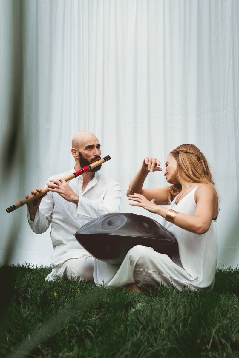 A portrait photograph of musicians sitting on grass by Fedor Vasilev