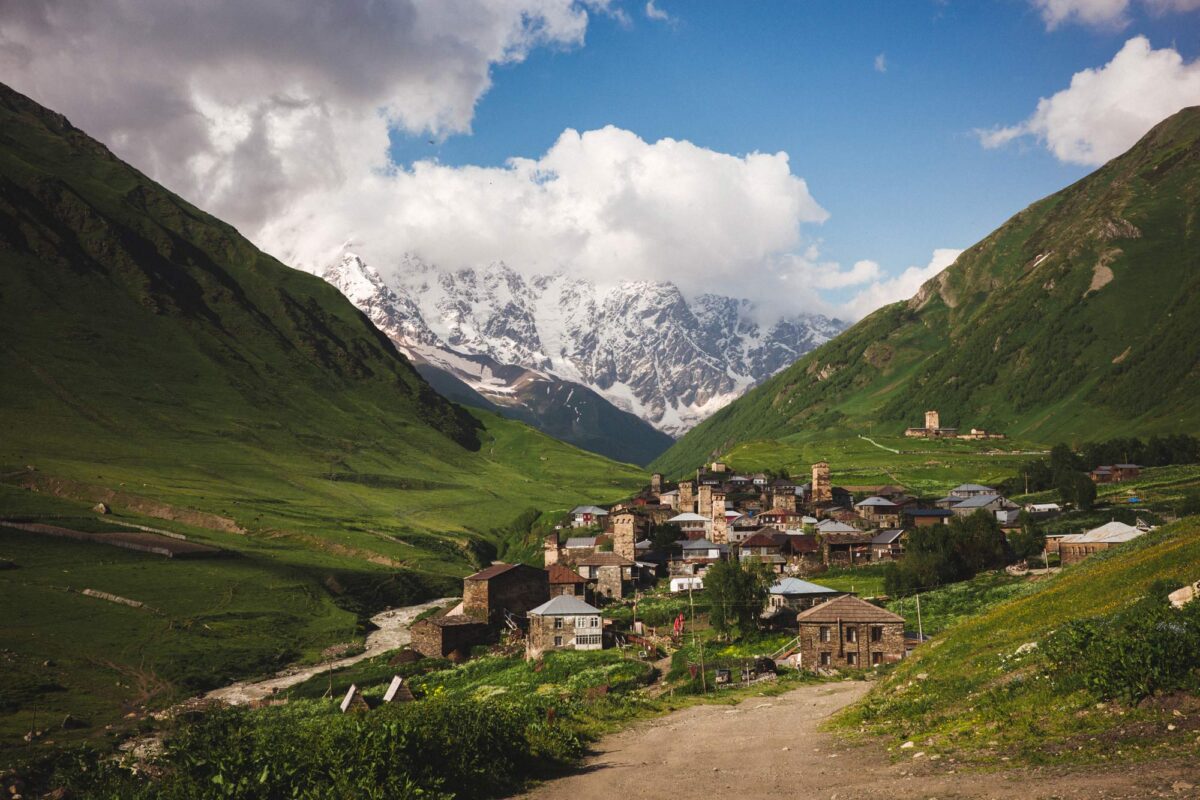 Landscape photograph of village Ushguli and Shkhara mountain on a sunny day