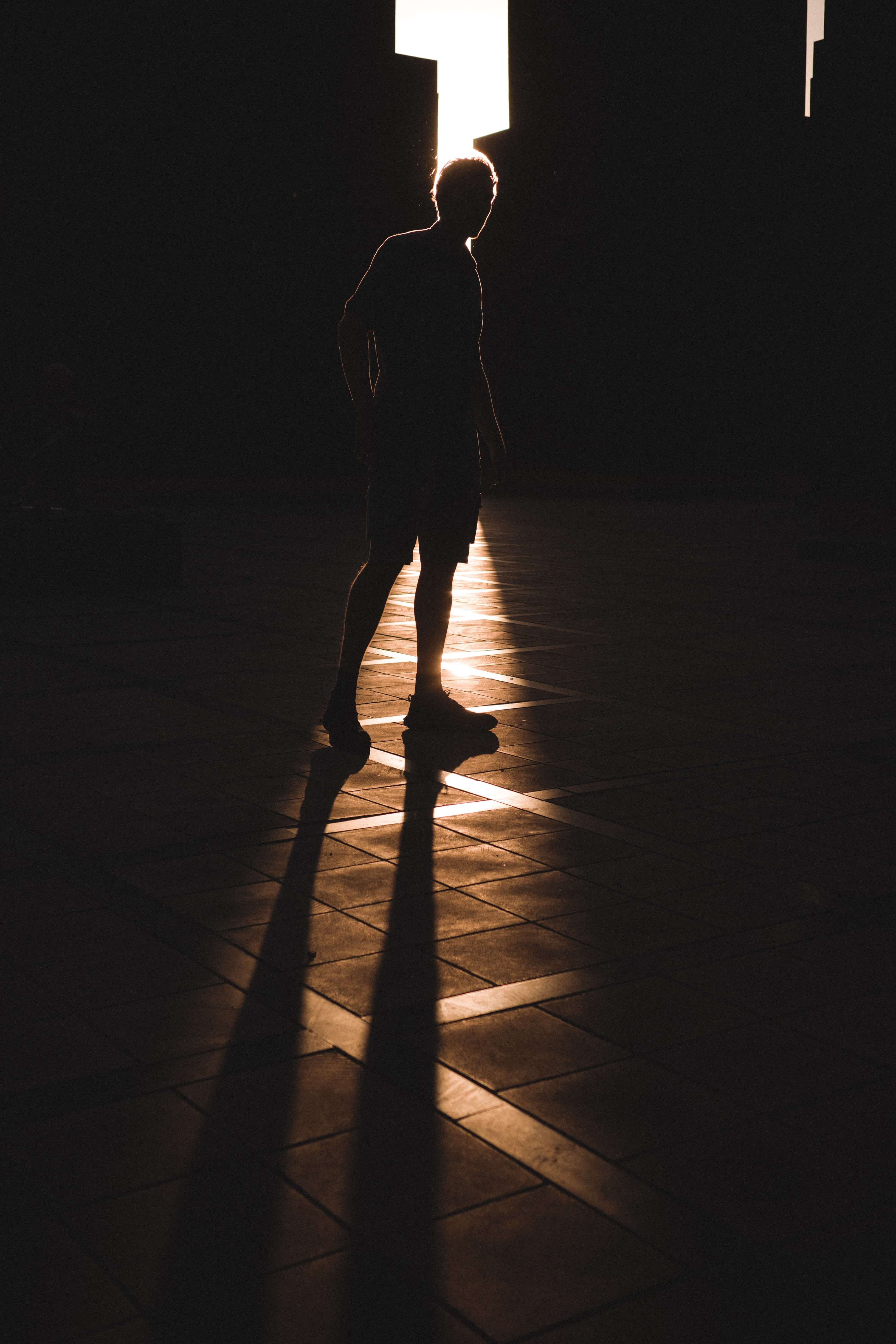 A picture of a silhouette of a man in a city shot with not shallow depth of field