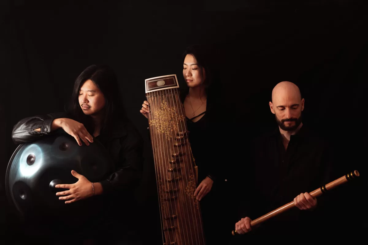 Portrait photograph of three musicians in Berlin in front of a black background
