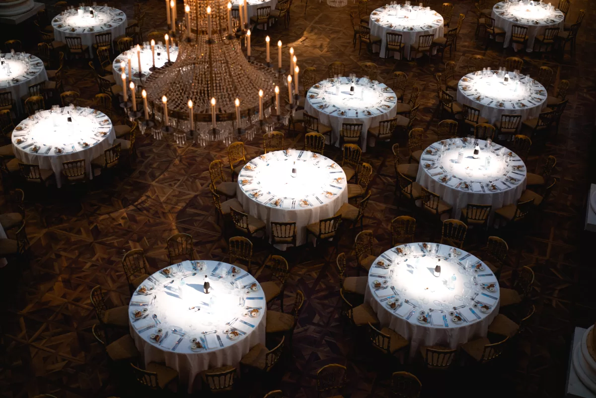 tables set for a gala dinner in a grand event hall by photographer Fedor Vasilev