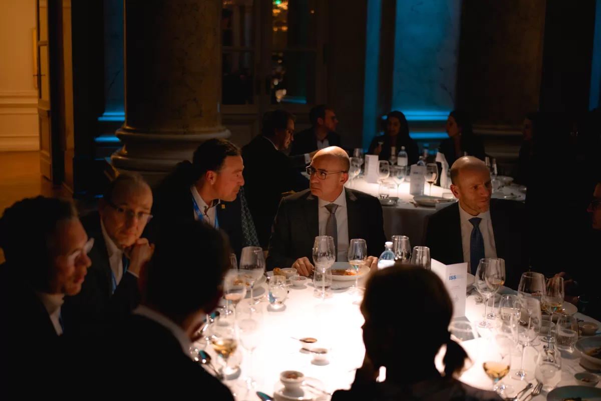 People sitting at a table at a gala dinner after a corporate event by corporate photographer Fedor Vasilev