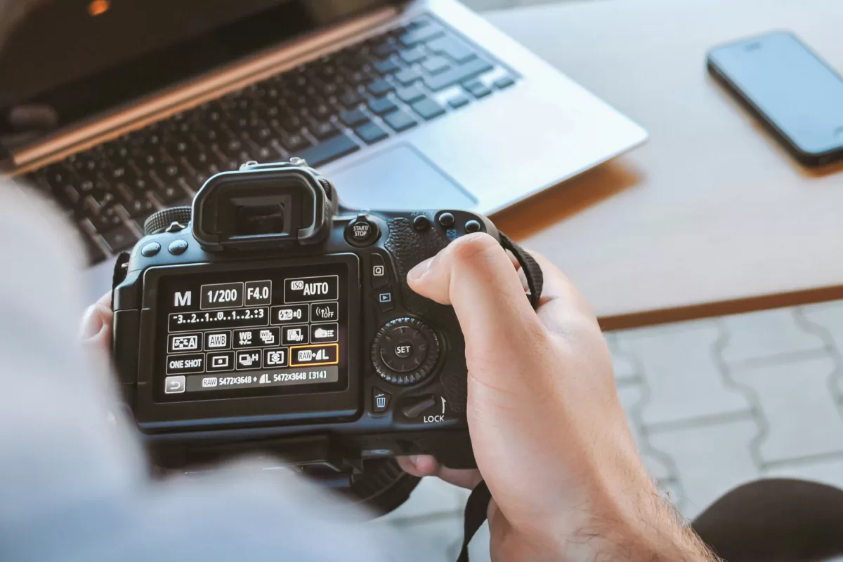 Person holding a camera, display on setting mode