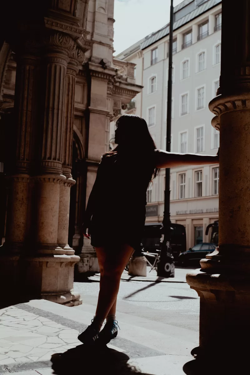 Silhouette of a woman next to opera house in Vienna by Vacation Photographer Fedor Vasilev