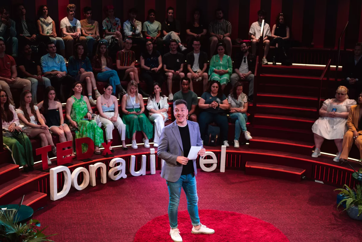 Speaker on an event in the middle of a stage opening a show