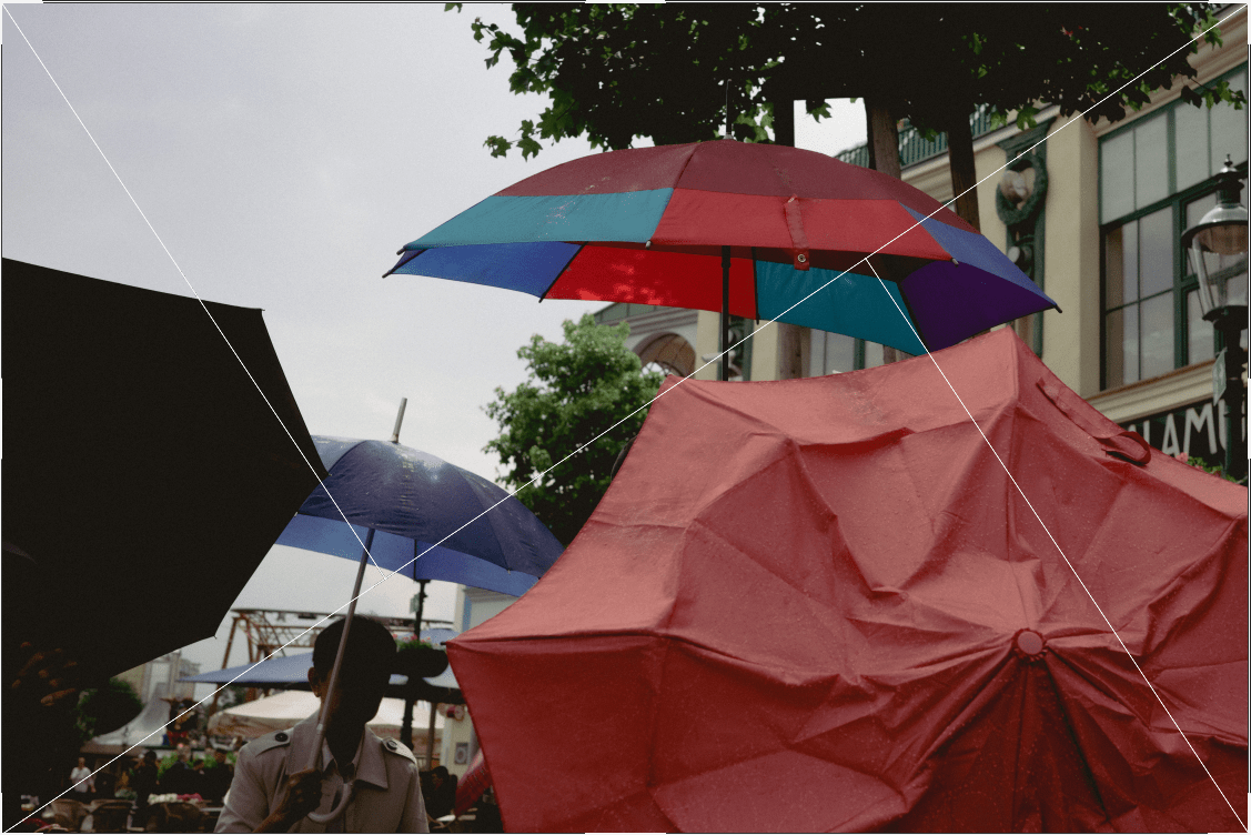 A photograph of people with umbrellas using the golden triangle grid as a guideline