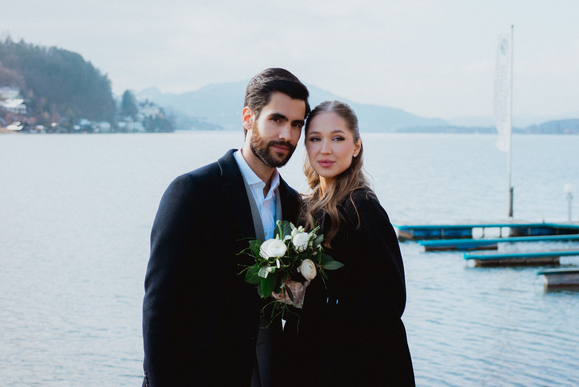 Couple standing in front of Wörthersee after their wedding ceremony