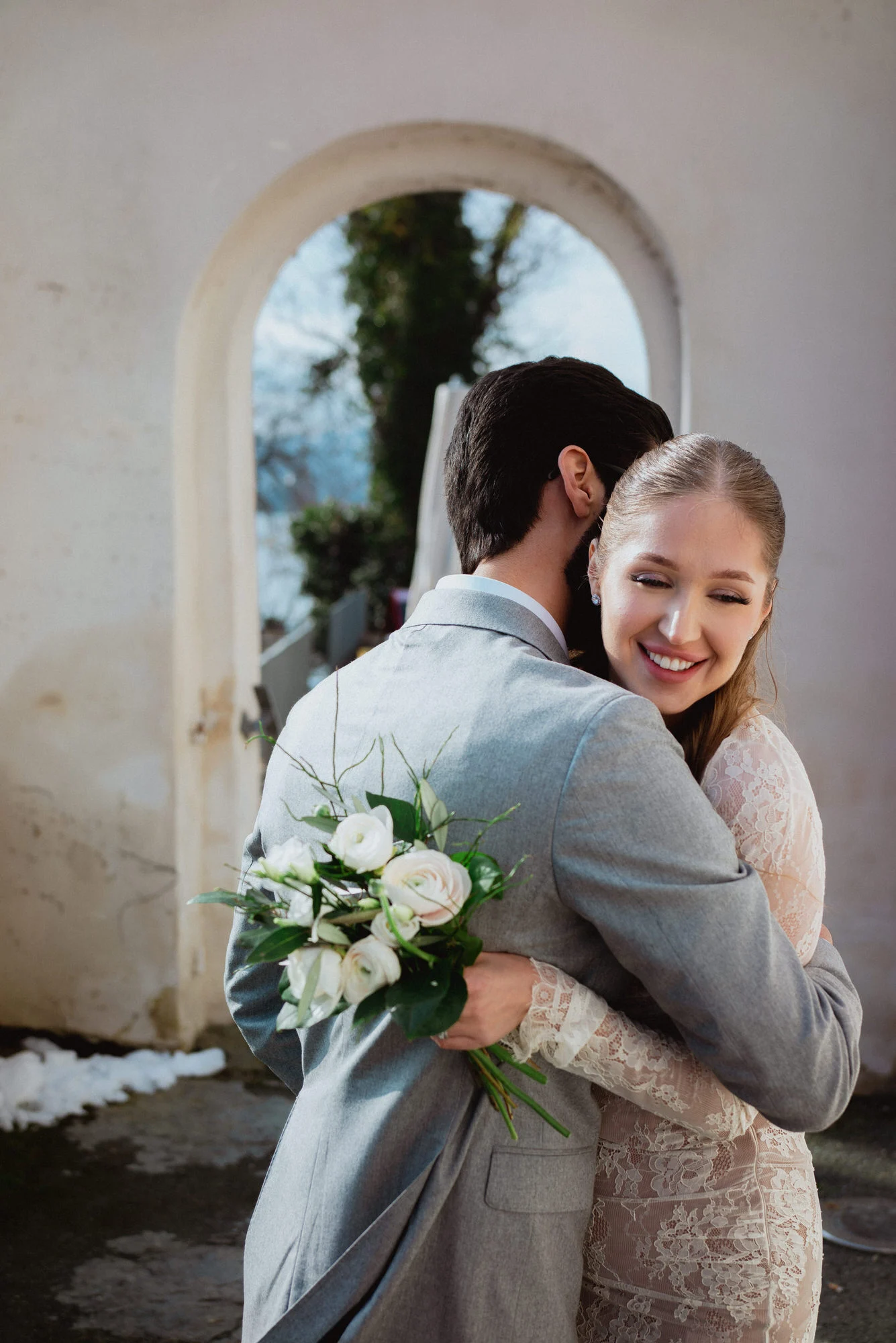 Lifestyle wedding photo in Klagenfurt Austria, newlyweds hugging in a beautiful location