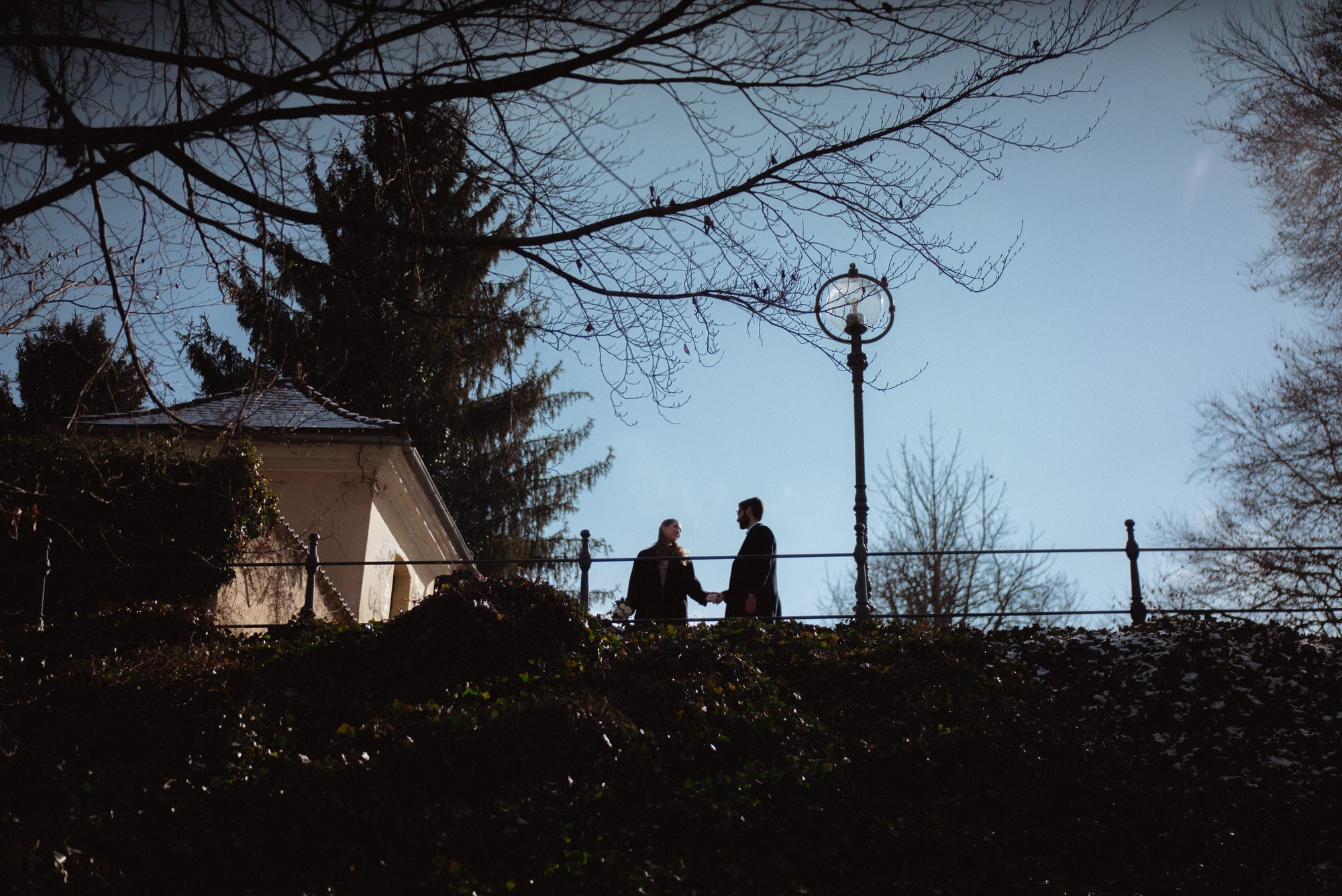 silhouette photo of a couple on a hillock