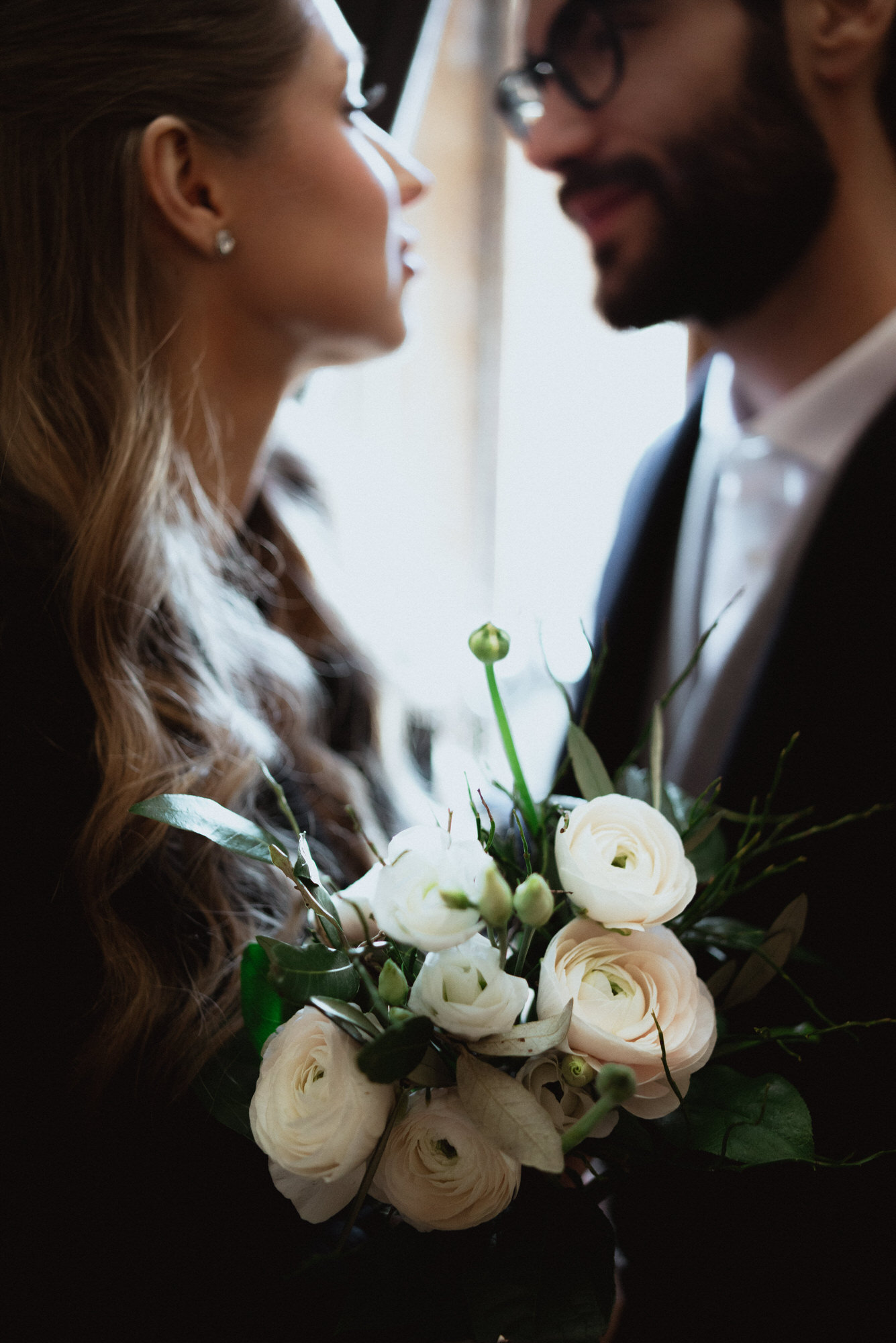 Closeup photo of bride and groom holding a bouquet 